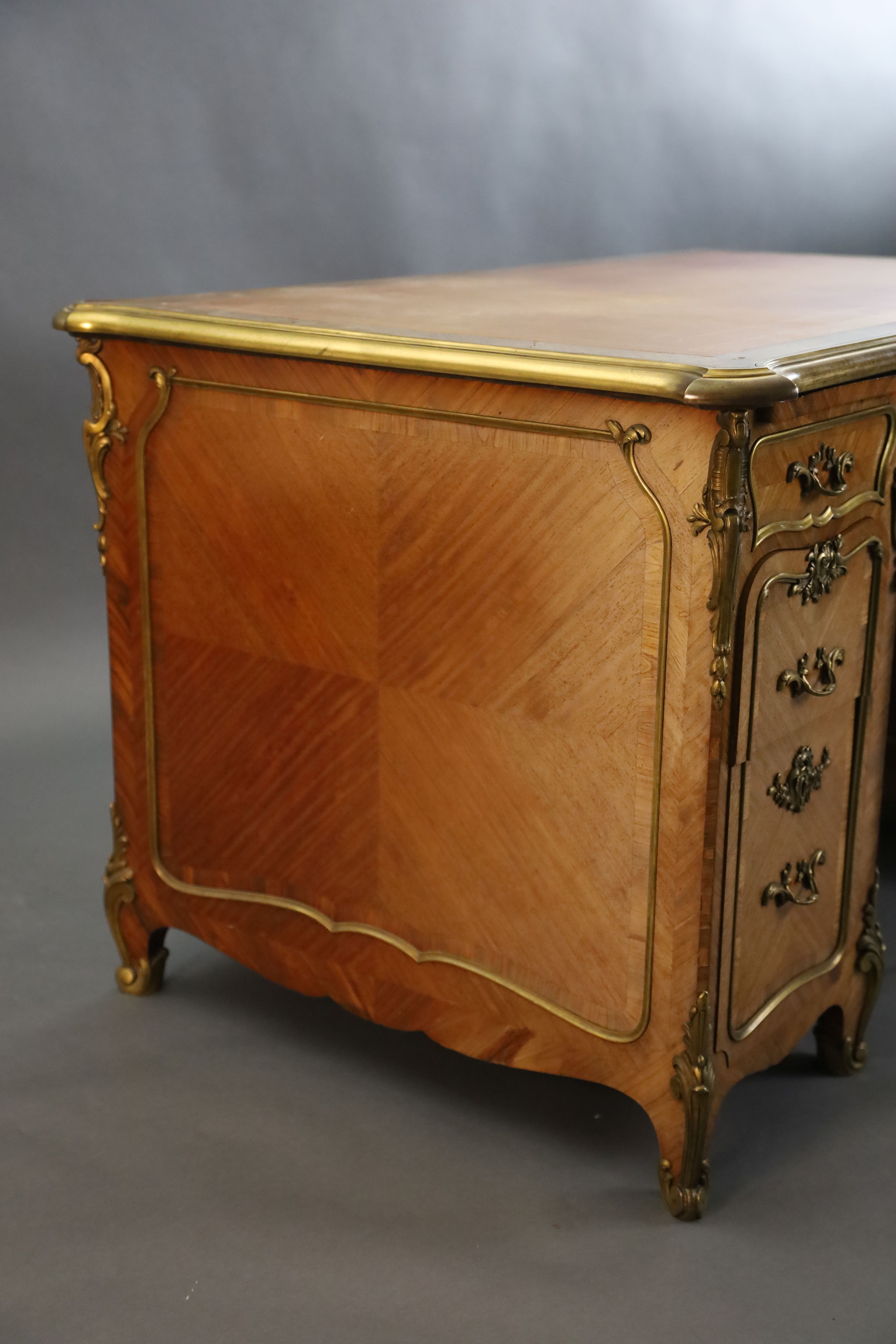 An early 20th century Louis XVI style ormolu mounted satinwood and rosewood kneehole desk, W.4ft 5in. D.2ft 8in. H.2ft 6in.
